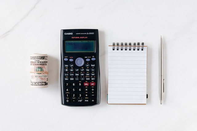 Money, calculator, pen and a piece of paper