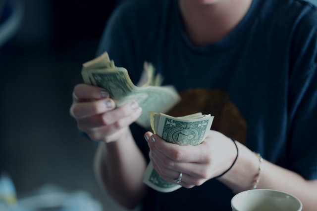 A person counting bills of money