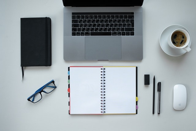 A laptop with notepad