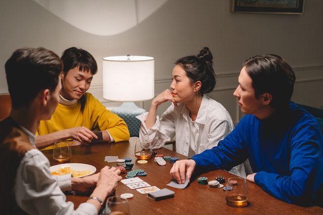 A group of people playing poker home game