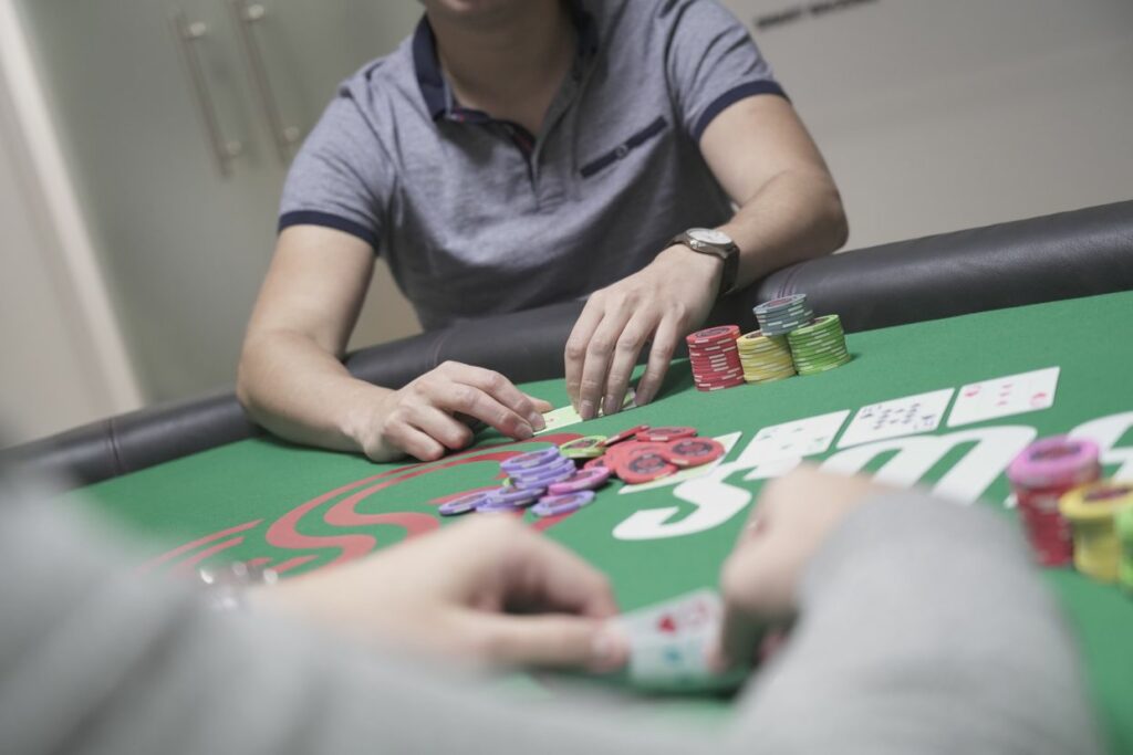 A person checking his poker hand