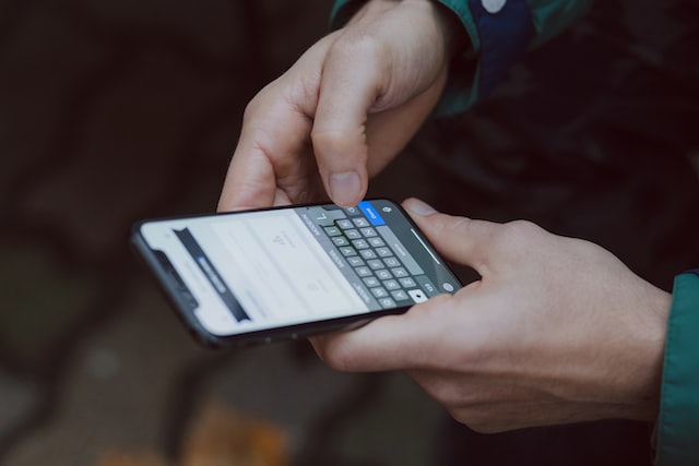 A person making a note on his smartphone