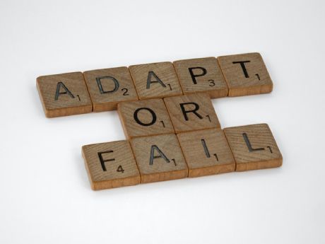 A picture of scrabble letters saying adapt or fail