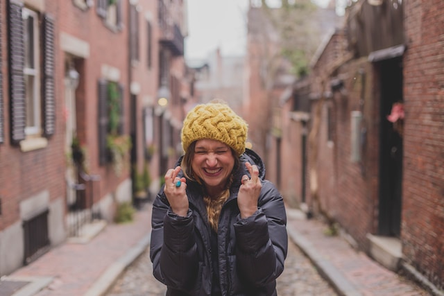 A picture of a person with her fingers crossed