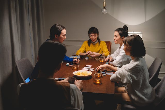 A picture showing a couple people playing a friendly home game of poker