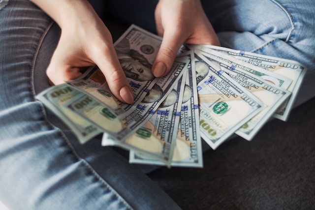 A picture of person counting money bills